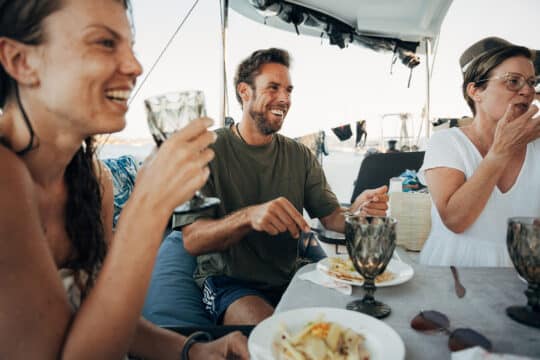 Agave catamaran guests eating onboard