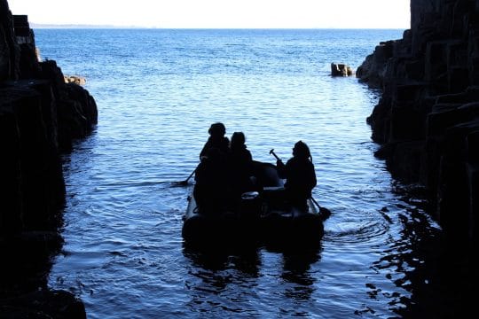 Guests on a rib exploring caves in Scotland