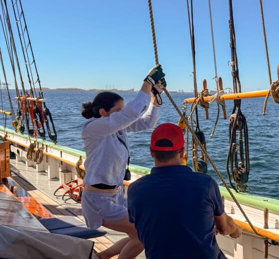 Aron guests onboard pulling ropes underway sailing onboard traditional tall ship
