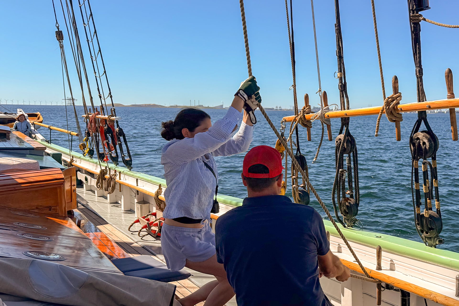 Aron guests onboard pulling ropes underway sailing onboard traditional tall ship
