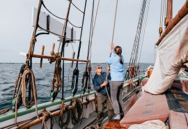 Aron guests pulling ropes onboard adventure sailing