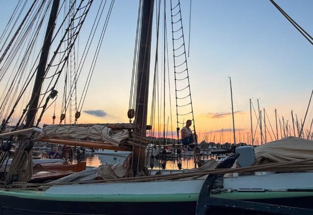 Aron tall ship at sunset guest on rigging on deck Scandinavia