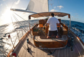 At helm of Chronos Rhea SC open ocean