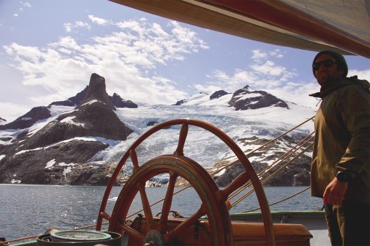 At helm of Tecla sailing in Greenland