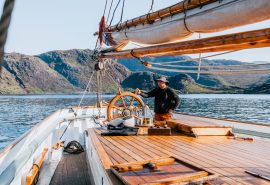 Bessie Ellen guest at helm sailing in Hebrides Scotland
