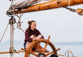 Bessie Ellen happy guest at helm
