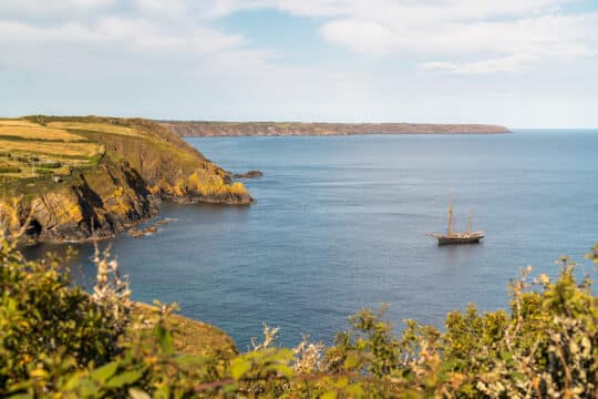 Bessie Ellen tall ship anchored off Cornish coast, Cadgwith, Cornwall