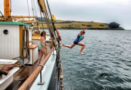Child jumping off Bessie Ellen to swim