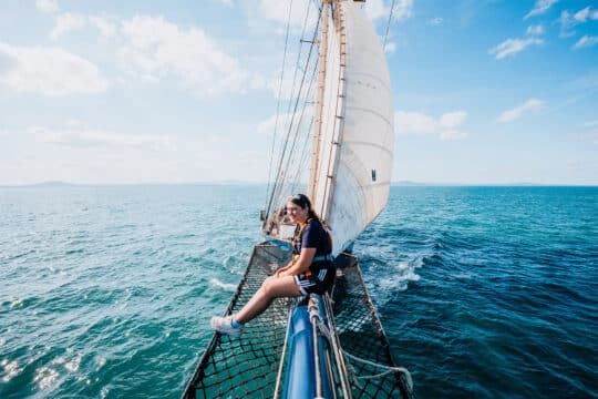 Blue Clipper Female Guest on Bowsprit solo traveller tall ship