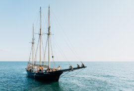Blue Clipper anchored guests on bowsprit sunshine