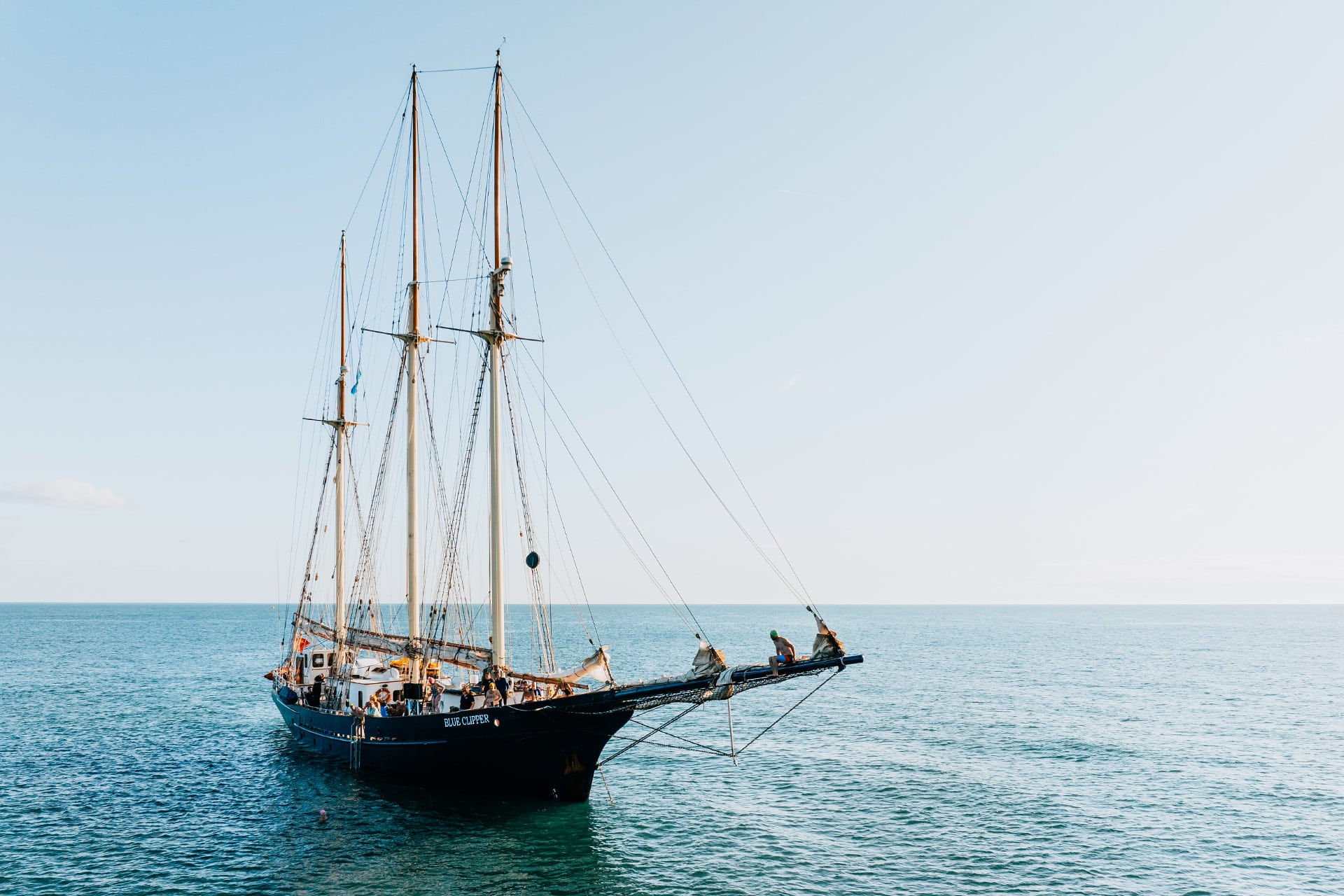 Blue Clipper anchored guests on bowsprit sunshine