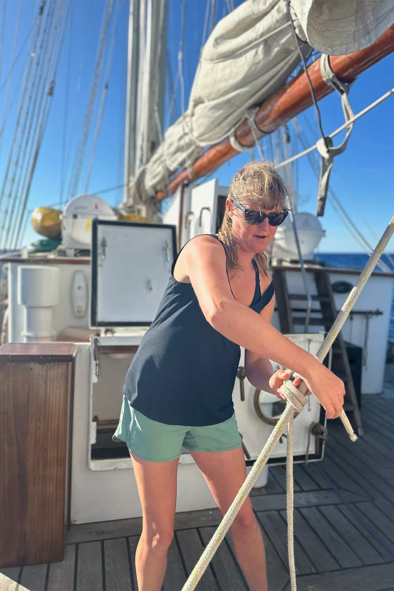 Blue Clipper guest tying ropes on board sailing