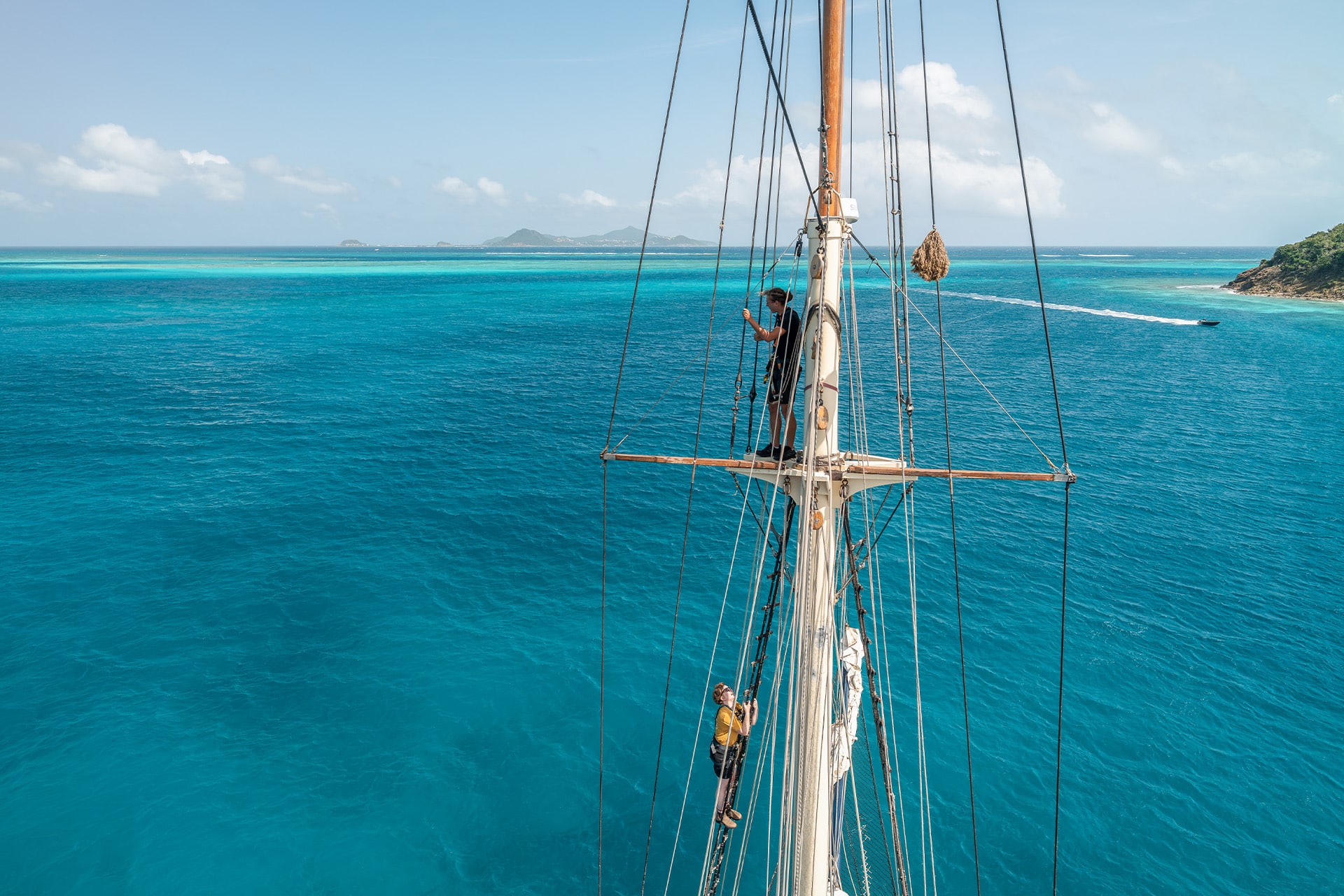 Blue Clipper guests climbing the mast at Tobago Cays, Caribbean tall ship