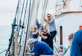 Blue Clipper guests raising sails tall ship