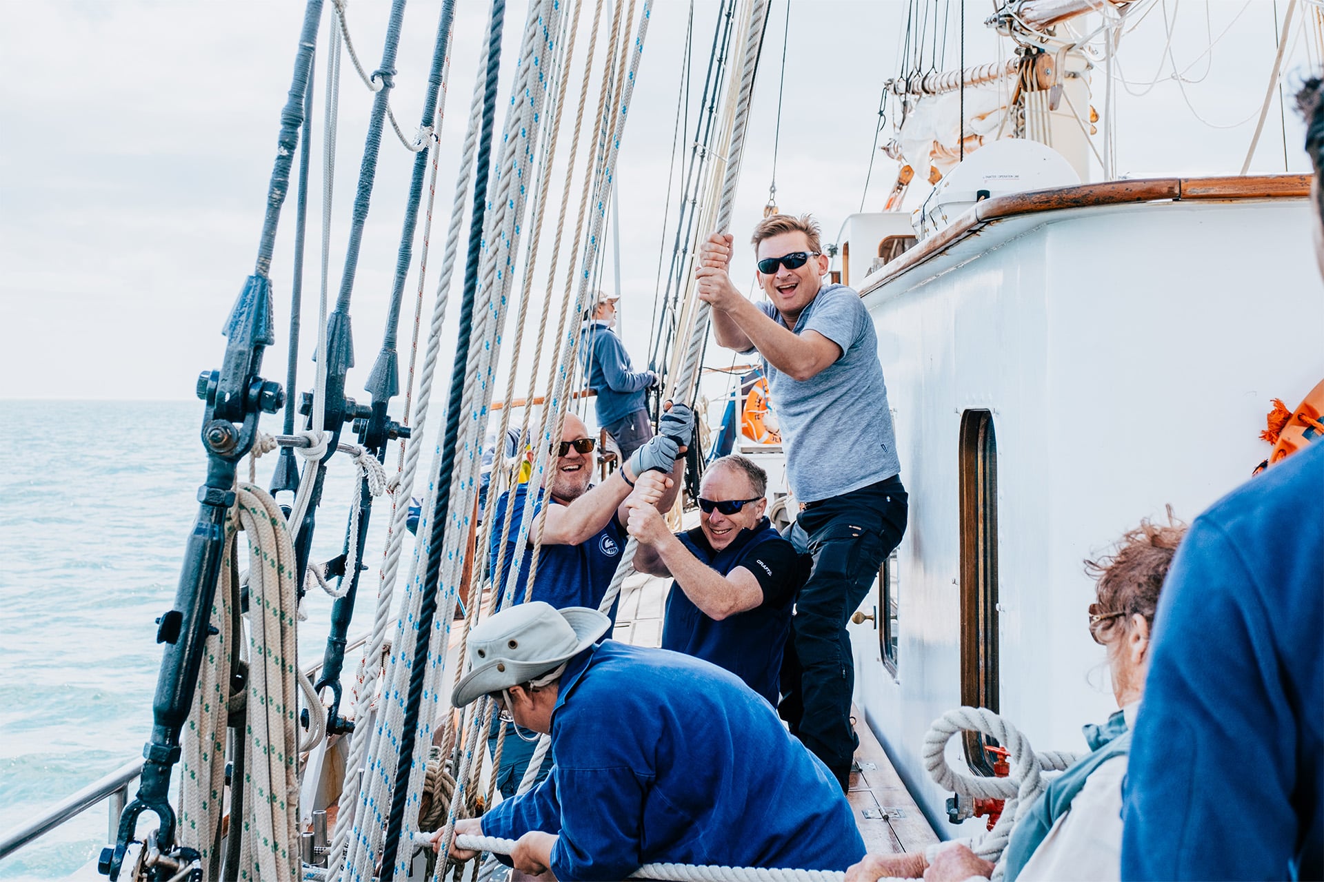Blue Clipper guests raising sails tall ship