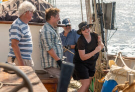 Blue Clipper guests raising the jib sails hands on tall ship