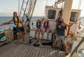 Blue Clipper tall ship guests on deck pulling ropes