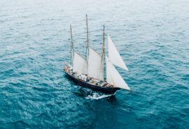 Blue Clipper tall ship sailing open ocean