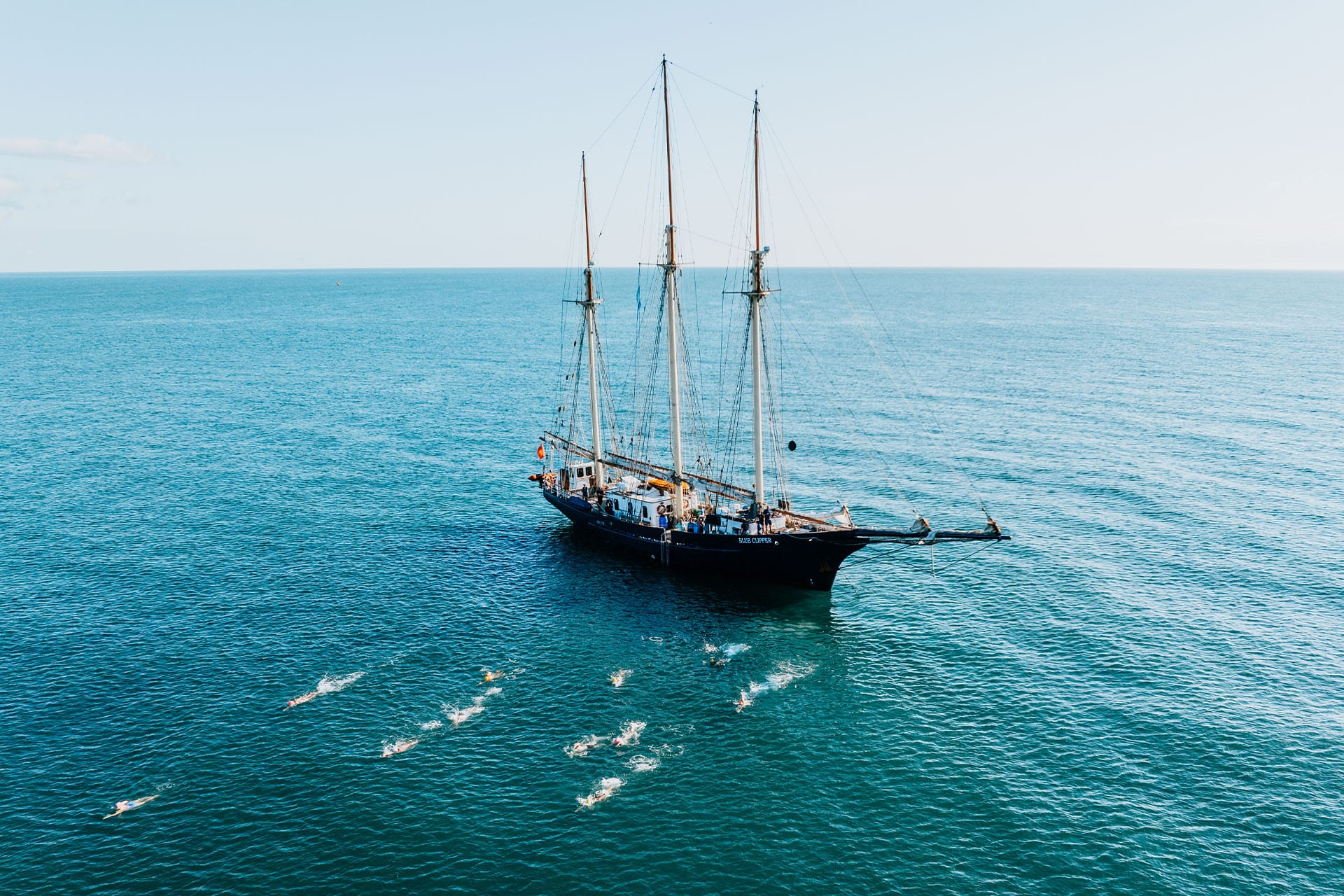 Blue Clipper tall ship with guests wild swimming