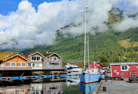Cherokee anchored in Norway with colourful cabins Norwegian Fjords