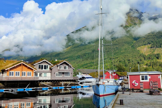 Cherokee anchored in Norway with colourful cabins Norwegian Fjords