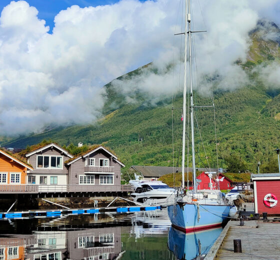 Cherokee anchored in Norway with colourful cabins Norwegian Fjords