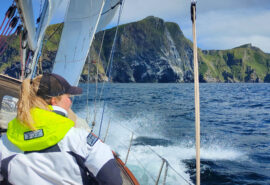 Cherokee guest female sailor on deck with view of Norwegian fjords