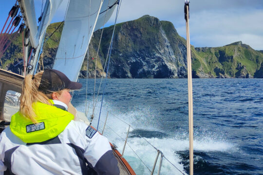 Cherokee guest female sailor on deck with view of Norwegian fjords