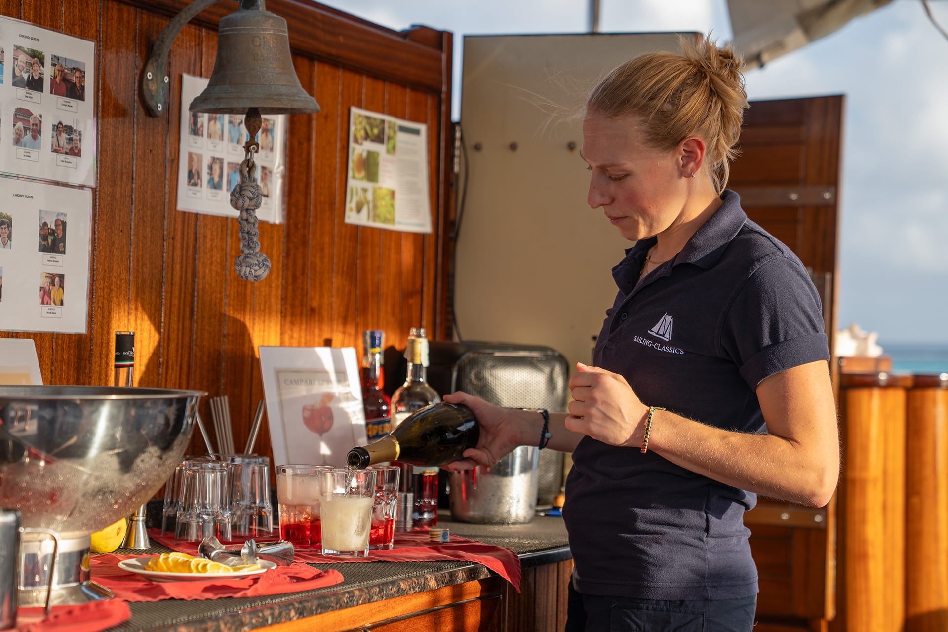 Chronos crew serving sundowners dining onboard on deck