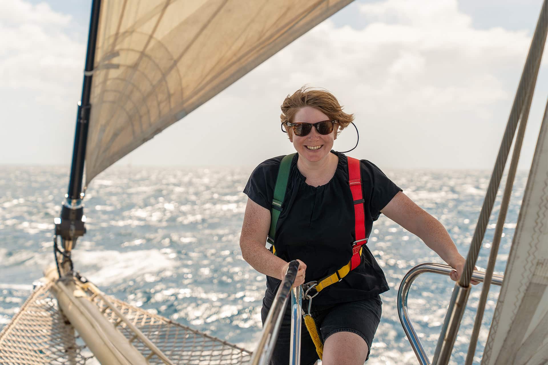 Chronos guest venturing onto bowsprit female solo sailor
