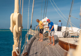 Chronos guests on deck tidying ropes onboard