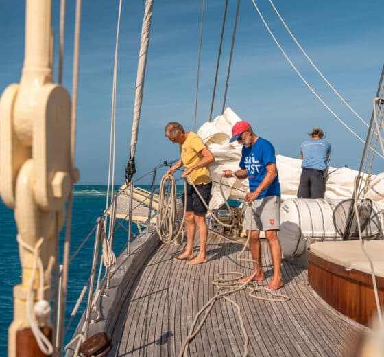 Chronos guests on deck tidying ropes onboard