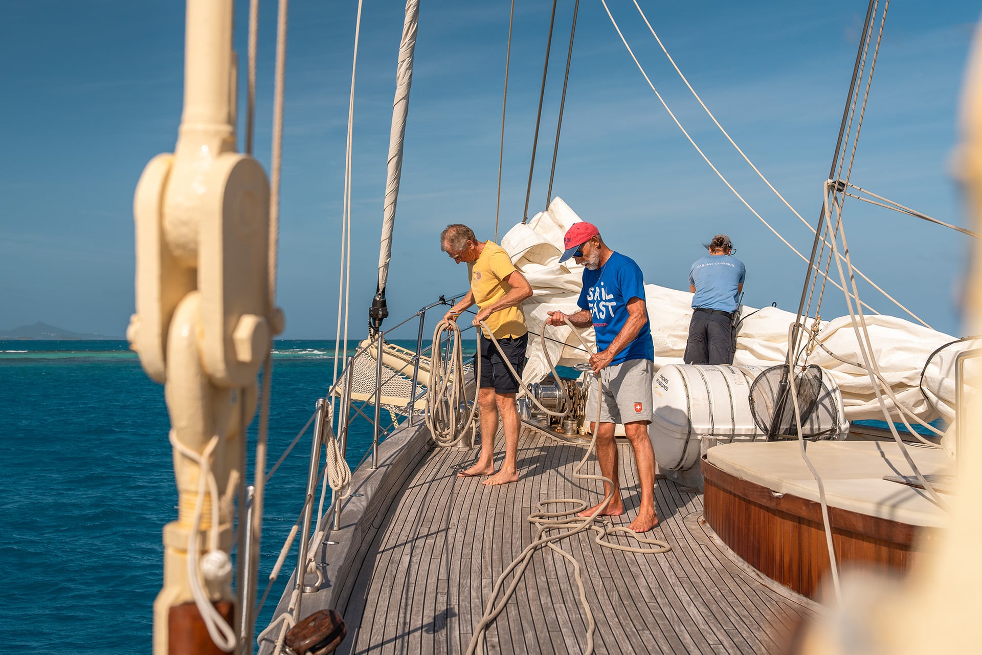 Chronos guests on deck tidying ropes onboard