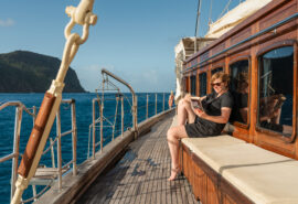 Chronos morning guest reading on deck sunshine