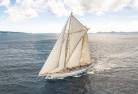 Chronos yacht underway full sail sailing off coast