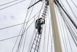 Climbing the mast on Blue Clipper