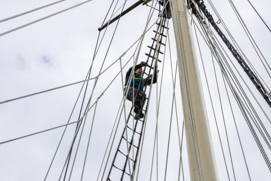 Climbing the mast on Blue Clipper