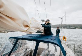 Emma Claire guest tidying sails on deck