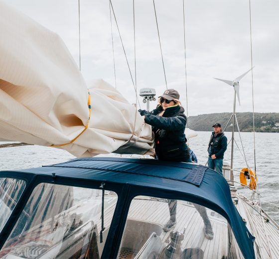 Emma Claire guest tidying sails on deck