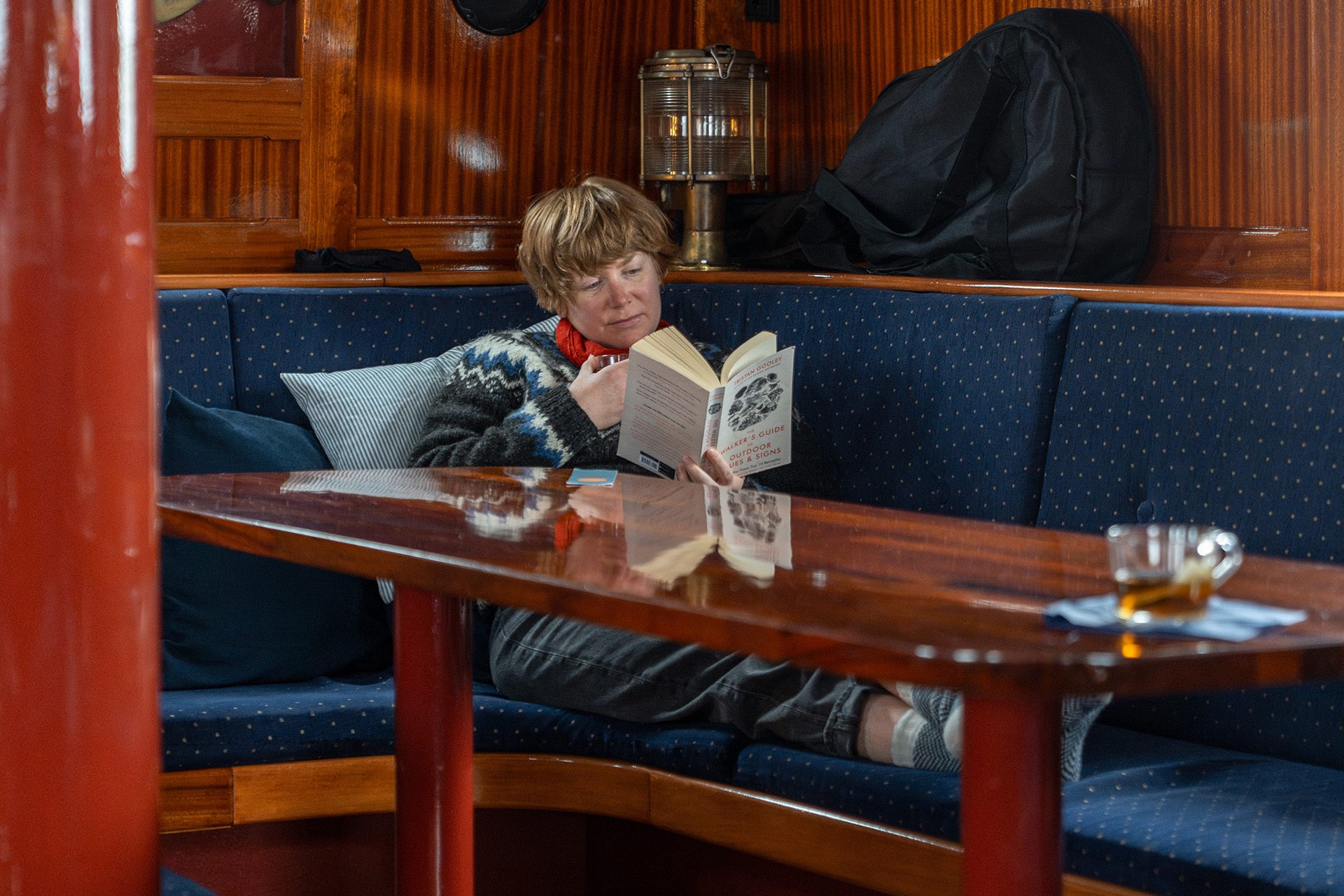 Flying Dutchman Guest onboard reading and relaxing in the saloon
