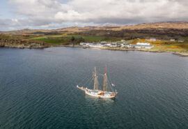 Flying Dutchman anchored off Ardberg whisky distillery, on Islay, Inner Hebrides, Scotland