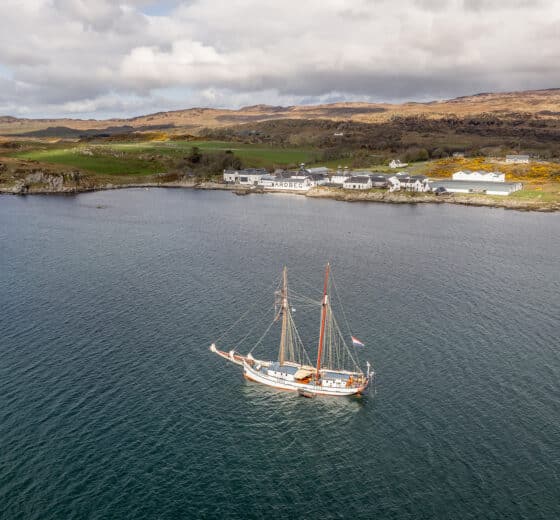 Flying Dutchman anchored off Ardberg whisky distillery, on Islay, Inner Hebrides, Scotland