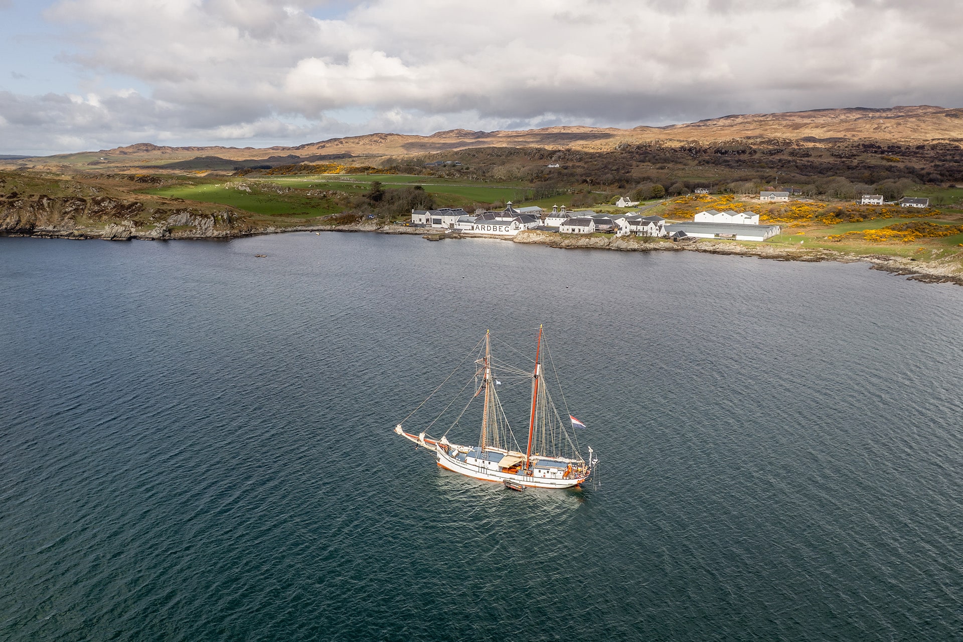 Flying Dutchman anchored off Ardberg whisky distillery, on Islay, Inner Hebrides, Scotland