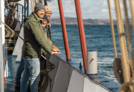 Flying Dutchman guests enjoying the coastal views onboard in the Hebrides, Scotland