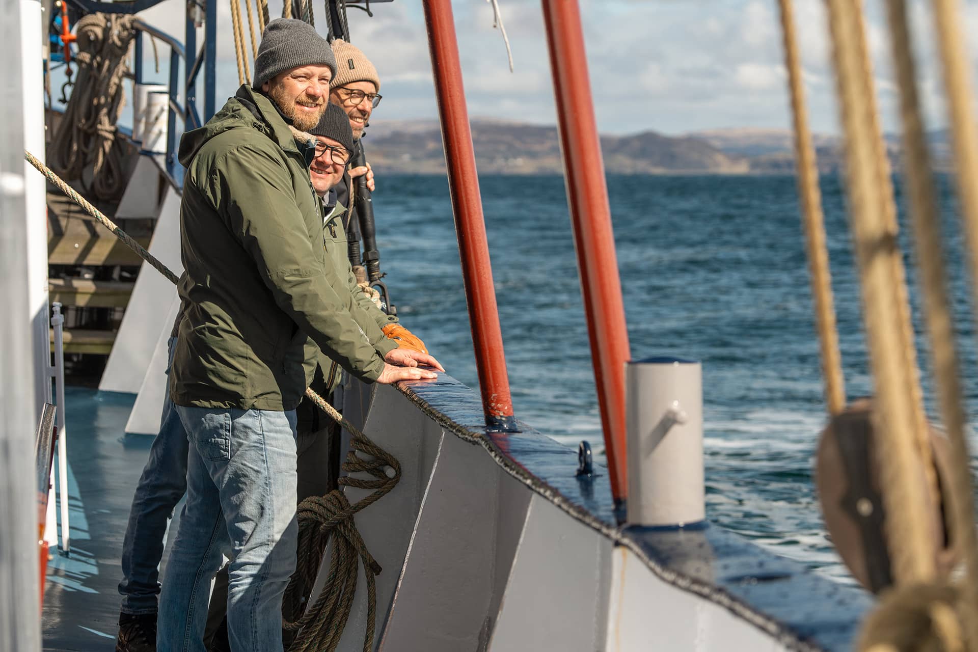 Flying Dutchman guests enjoying the coastal views onboard in the Hebrides, Scotland