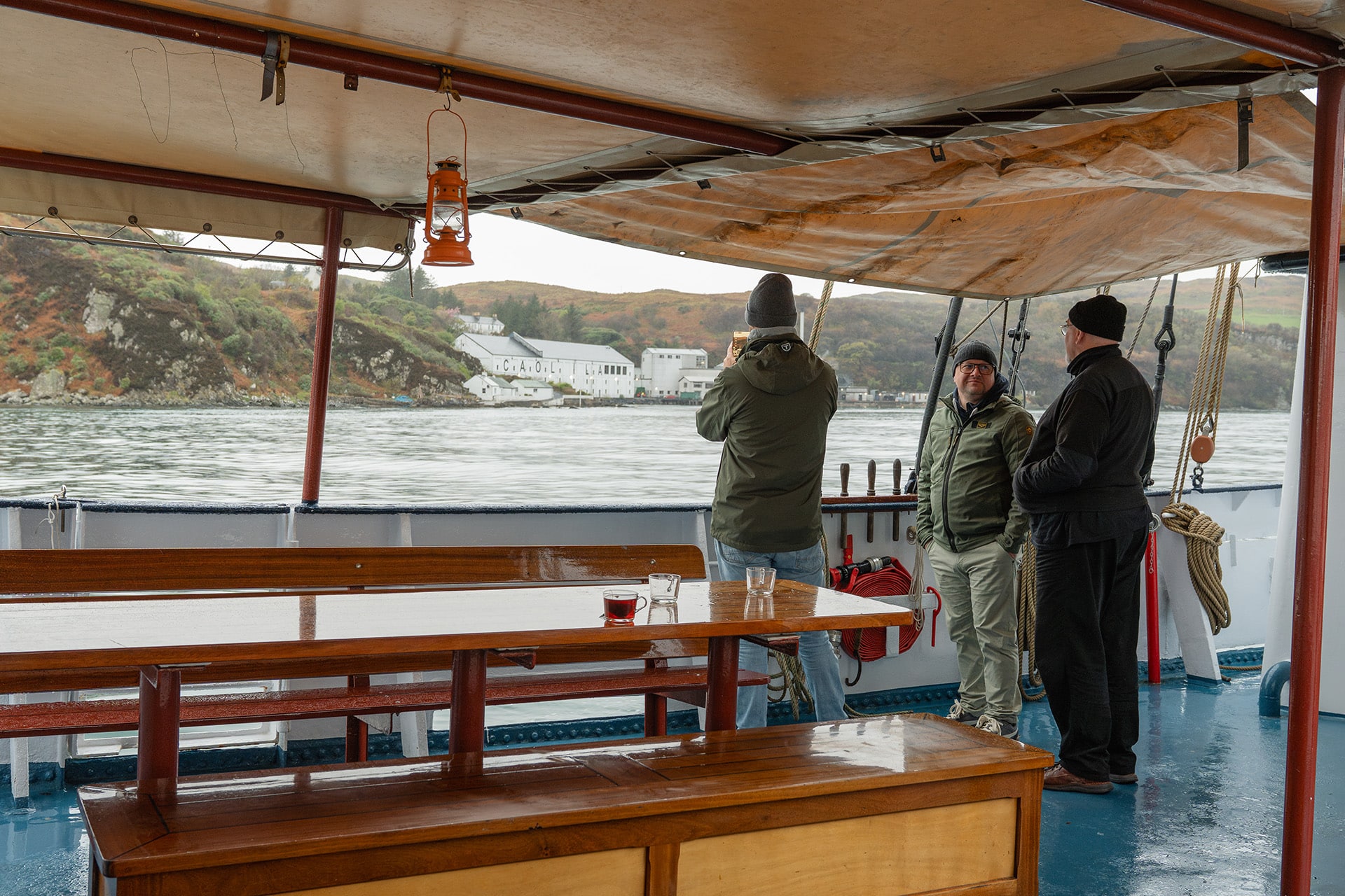 Flying Dutchman guests on deck relaxing with coffee taking in the views of the Hebrides, Scotland