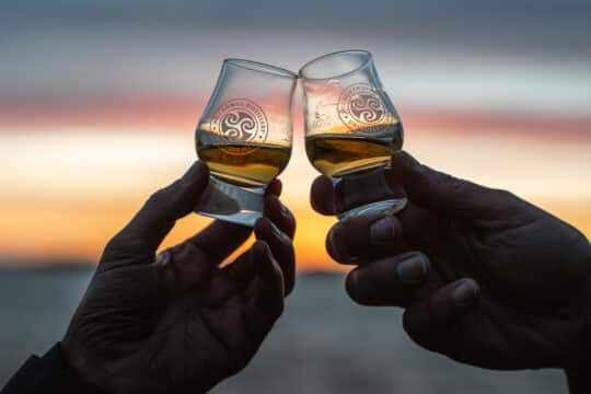 Flying Dutchman guests toasting Scottish whisky Hebrides, Scotland