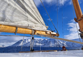 Goxsheim view on deck of snowy mountains Arctic Circle Sailing Svalbard traditional boat