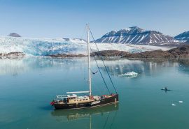 Guest kayaking with Valiente anchored in Arctic Svalbard