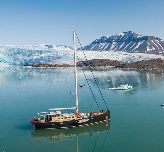 Guest kayaking with Valiente anchored in Arctic Svalbard